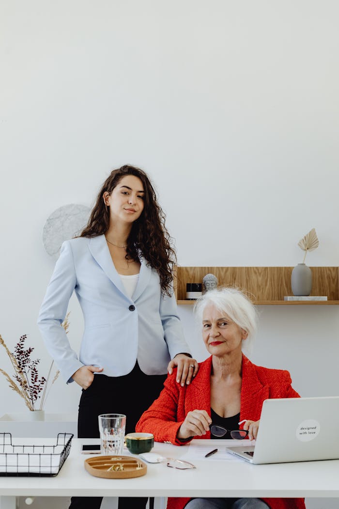 Two women working together in a modern office setting, blending expertise and innovation.